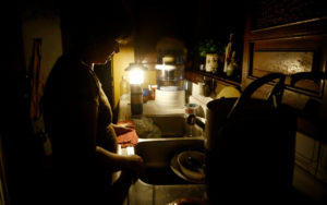 A woman washes dishes in the middle of a blackout in Venezuela