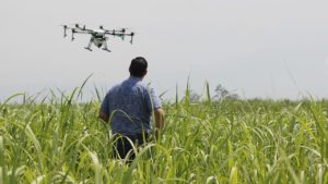 man operates a drone in a field