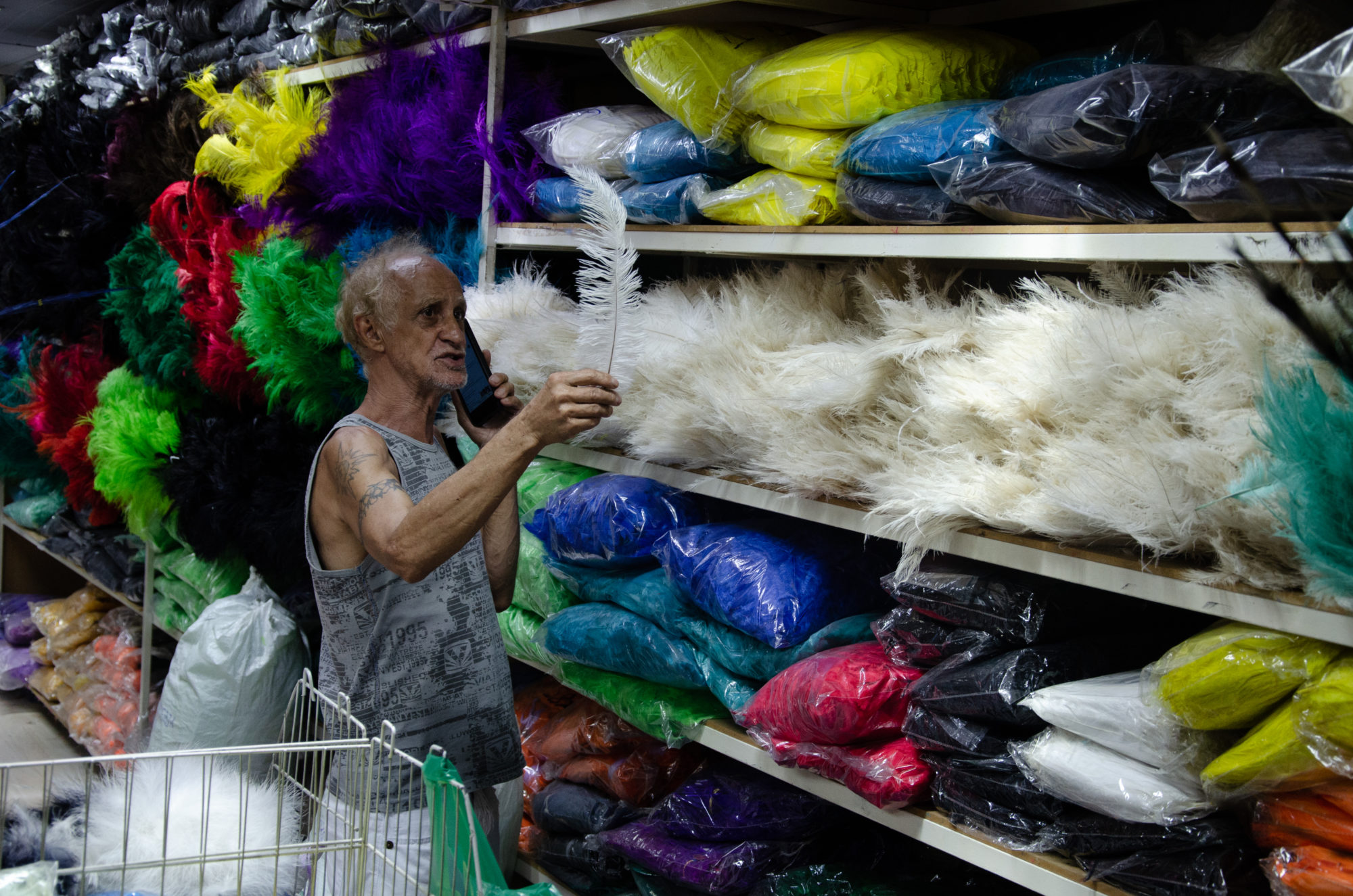 Jorge Francisco shows off the feathers he buys from China 