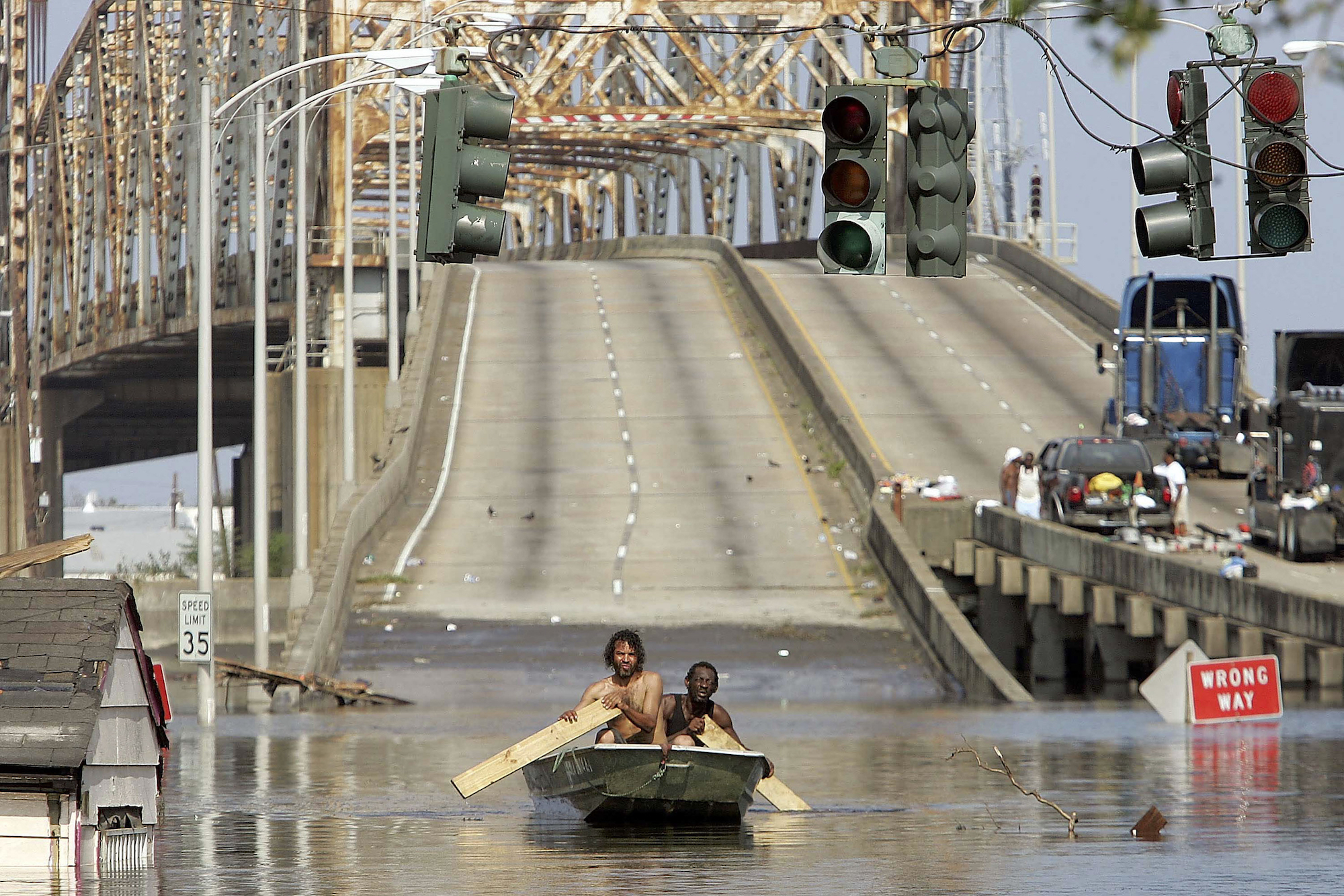 wo men paddle through New Orleans after Hurricane Katrina