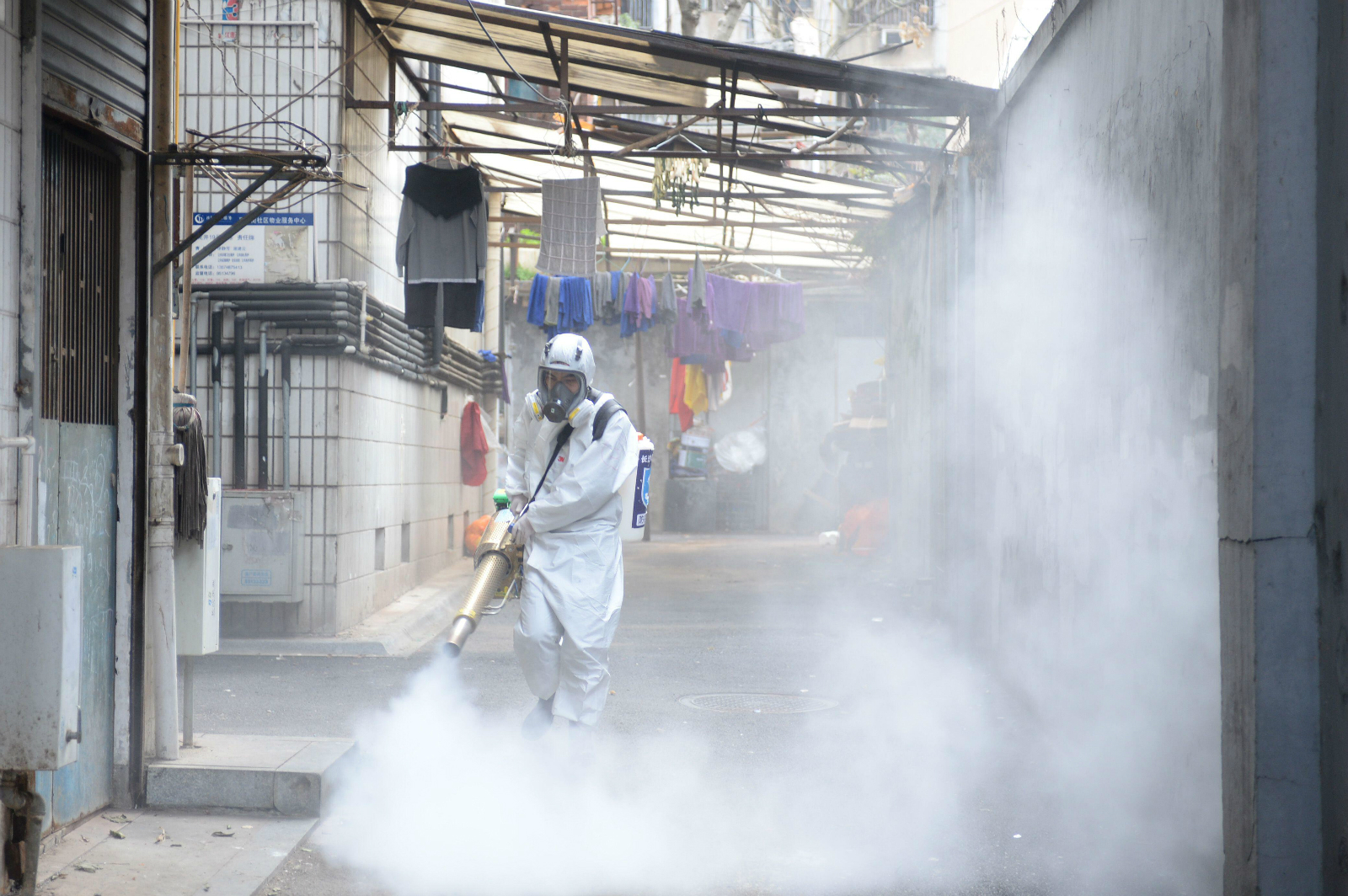 volunteer sprays disinfectant in Changsha, Hunan province