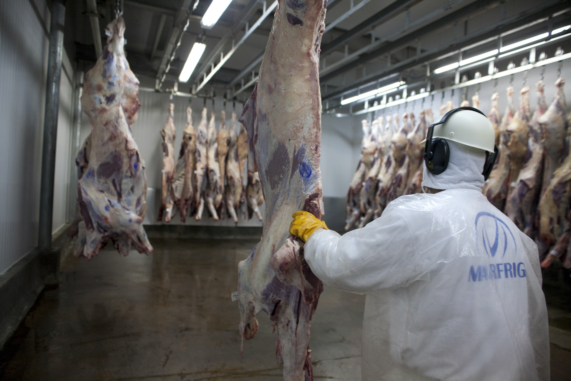 A worker butchers livestock in Marfrig slaughterhouse facility in Brazil