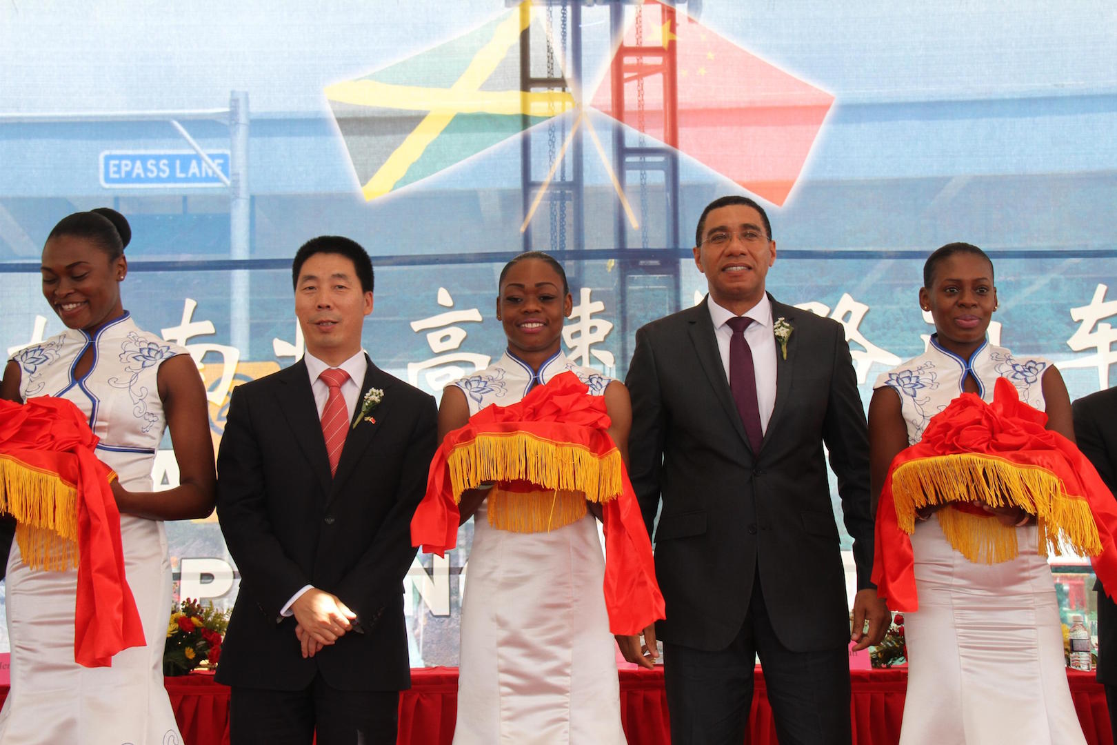 Jamaican Prime Minister Andrew Holness (2nd R) and Chinese Ambassador to Jamaica Niu Qingbao (2nd L) attend the ribbon cutting ceremony for CCCC's North-South Highway in Caymanas, Jamaica