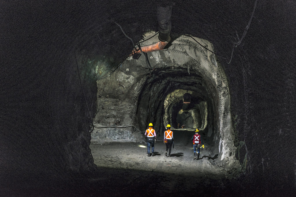 Three employees in a tunnel at the Buriticá gold mine, operated by the Chinese company Zijin.