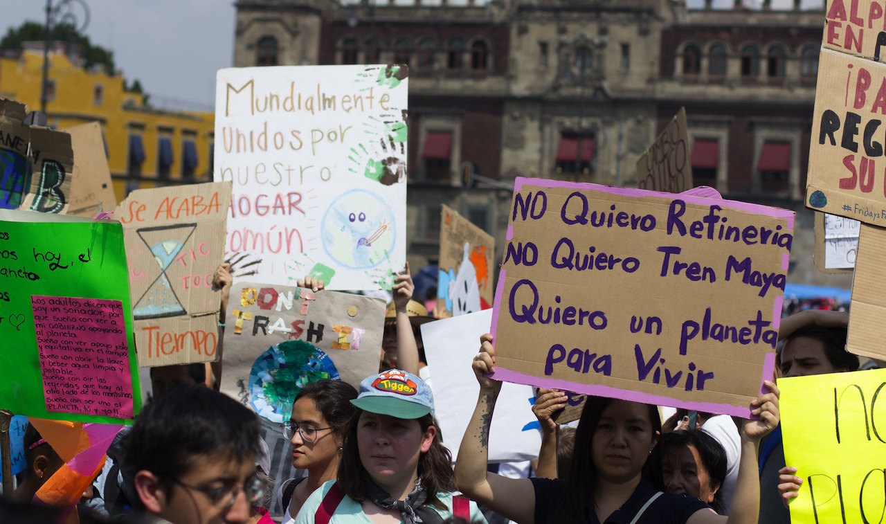 <p>A protestor holds a placard that reads: &#8220;I don&#8217;t want a refinery. I don&#8217;t want the Mayan Train. I want a planet to live in&#8221; (image: <a href="https://www.flickr.com/photos/151300191@N05/46700623854/">Francisco Colín Varela</a>)</p>