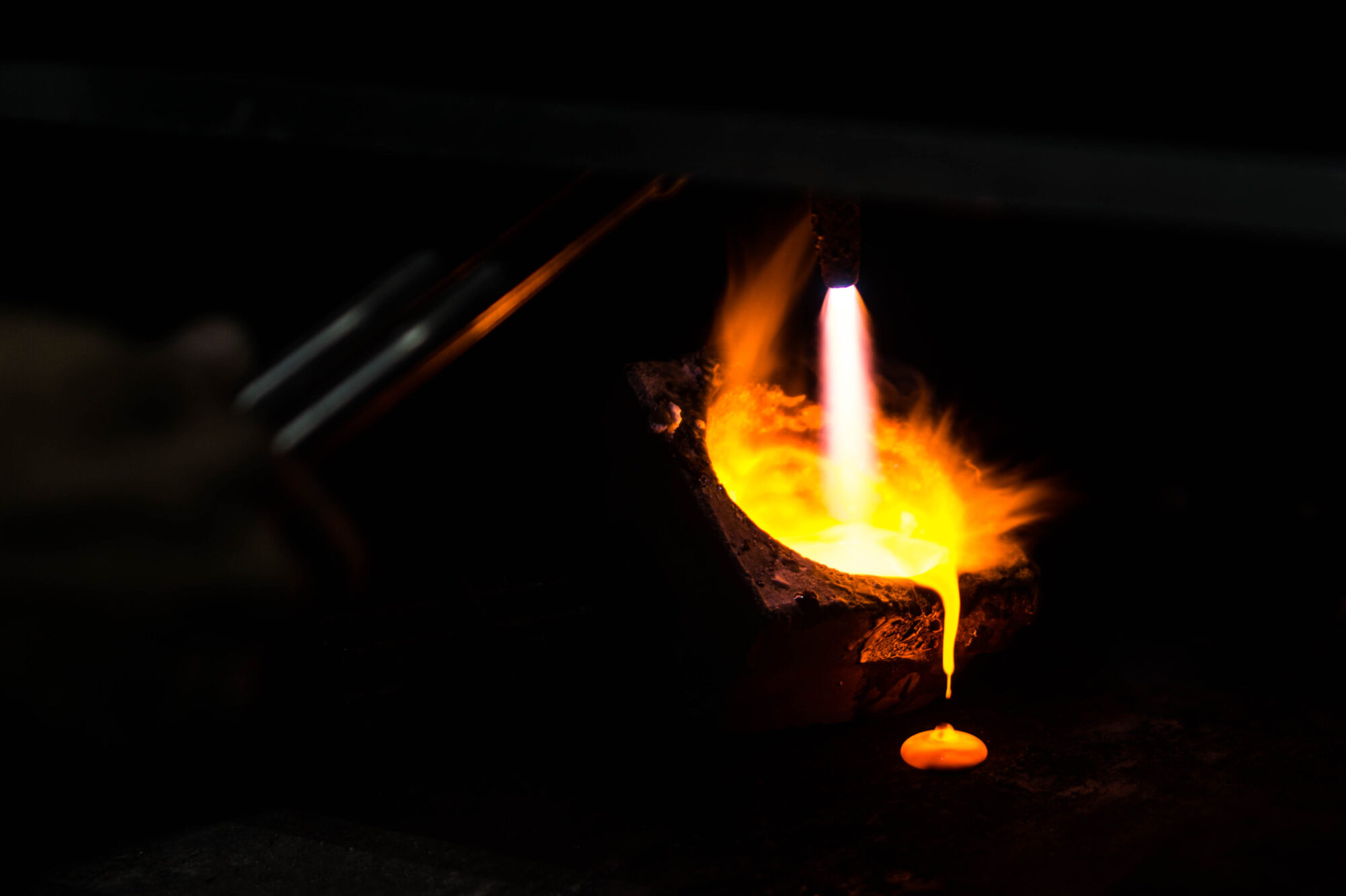 A worker burns off surplus mercury from the gold