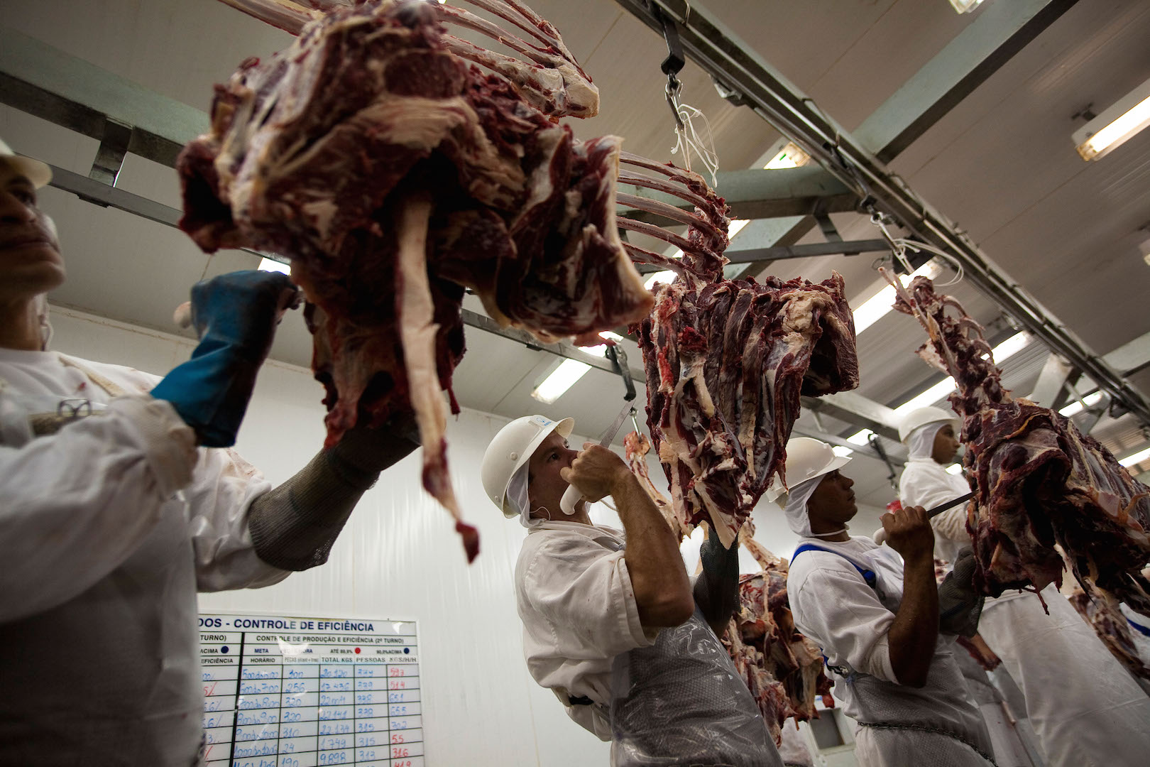 men working at a slaughterhouse in Mato Grosso state, Brazil