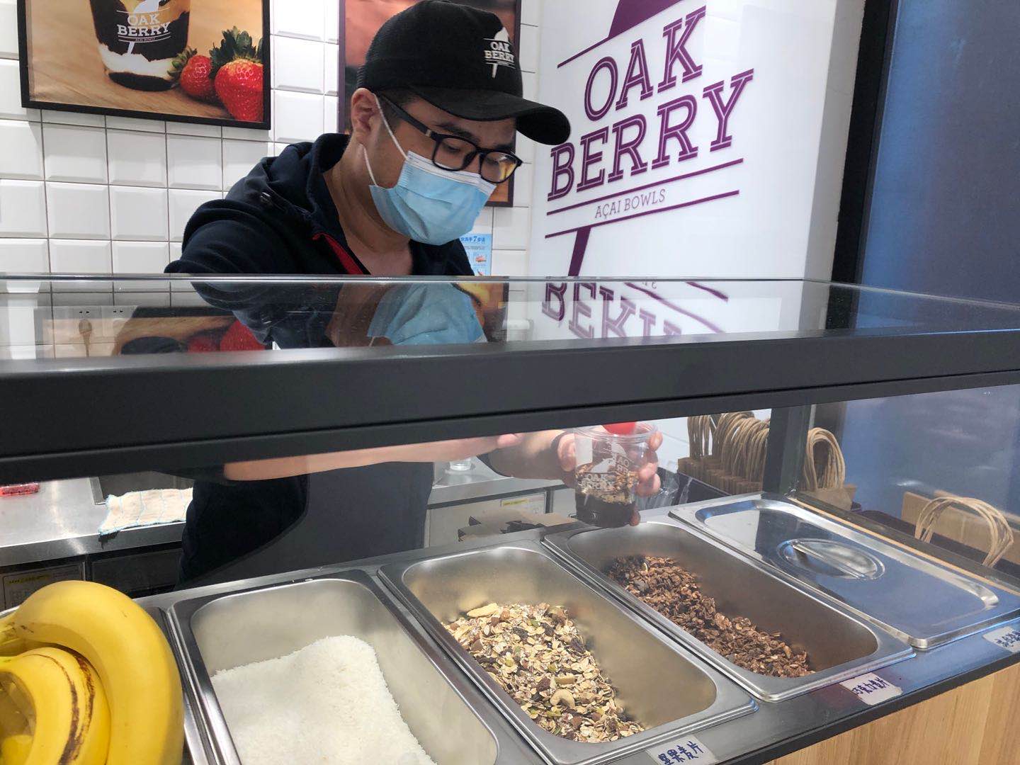 An employee serves a portion of açaí at Oakberry’s shop in Shanghai