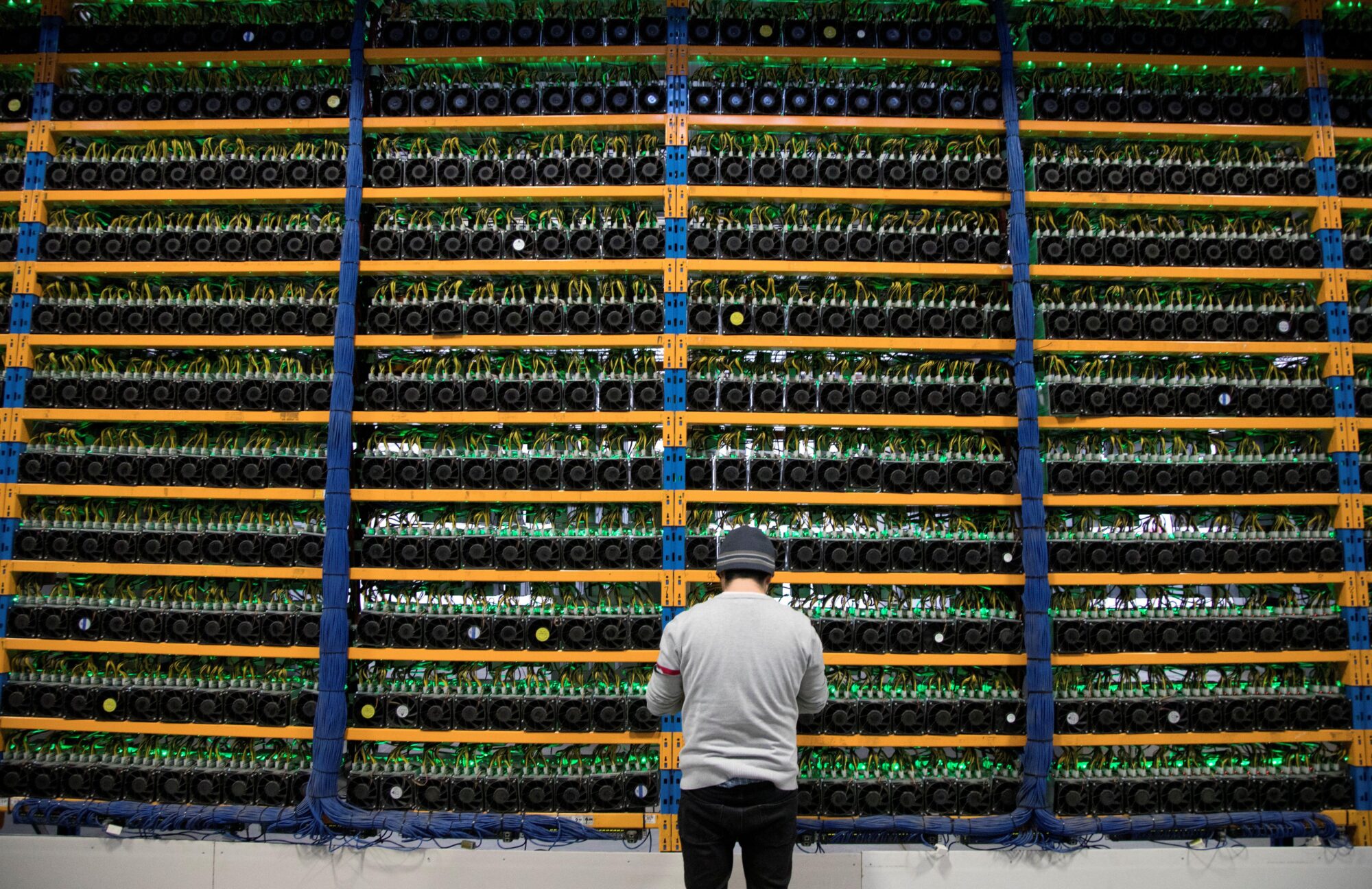 A worker checks the fans at a cryptocurrency farming operation