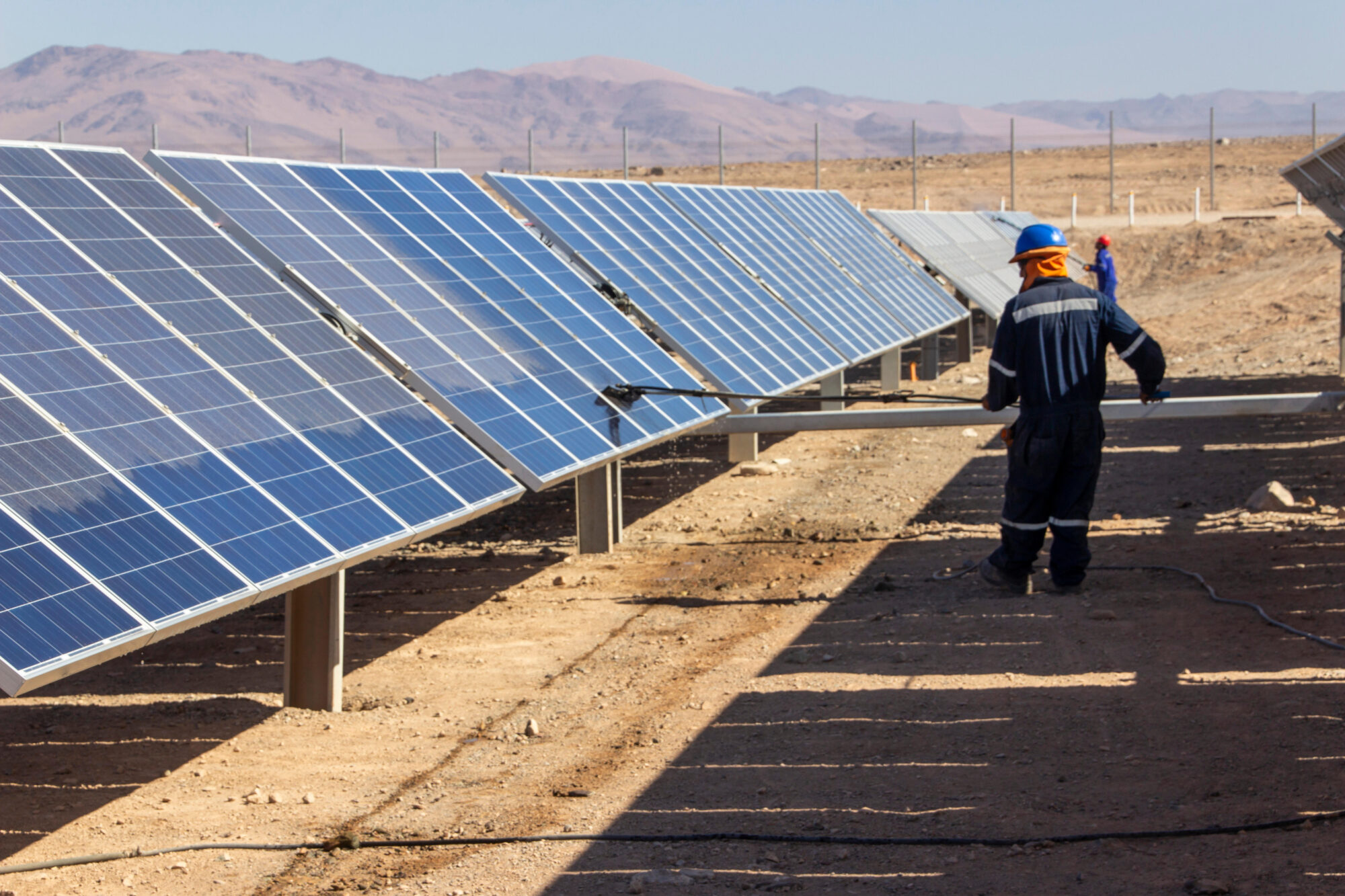 <p>Solar panels are cleaned in the Atacama desert. Chile has had notable successes in increasing renewable energy capacity in recent years, but like many in Latin America, still faces financial and political obstacles in the transition away from fossil fuels. (Image: Francisco Javier Ramos Rosellon / Alamy)</p>