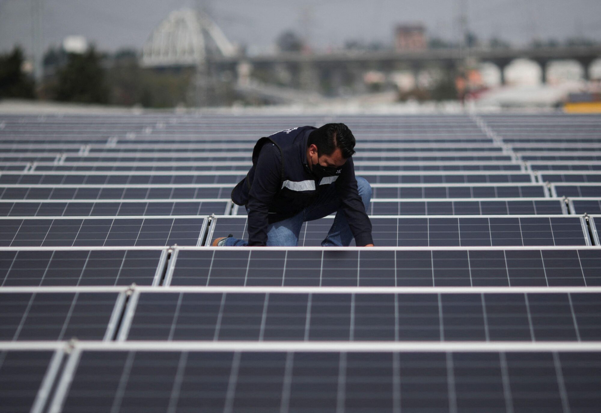 A worker installs a solar panel
