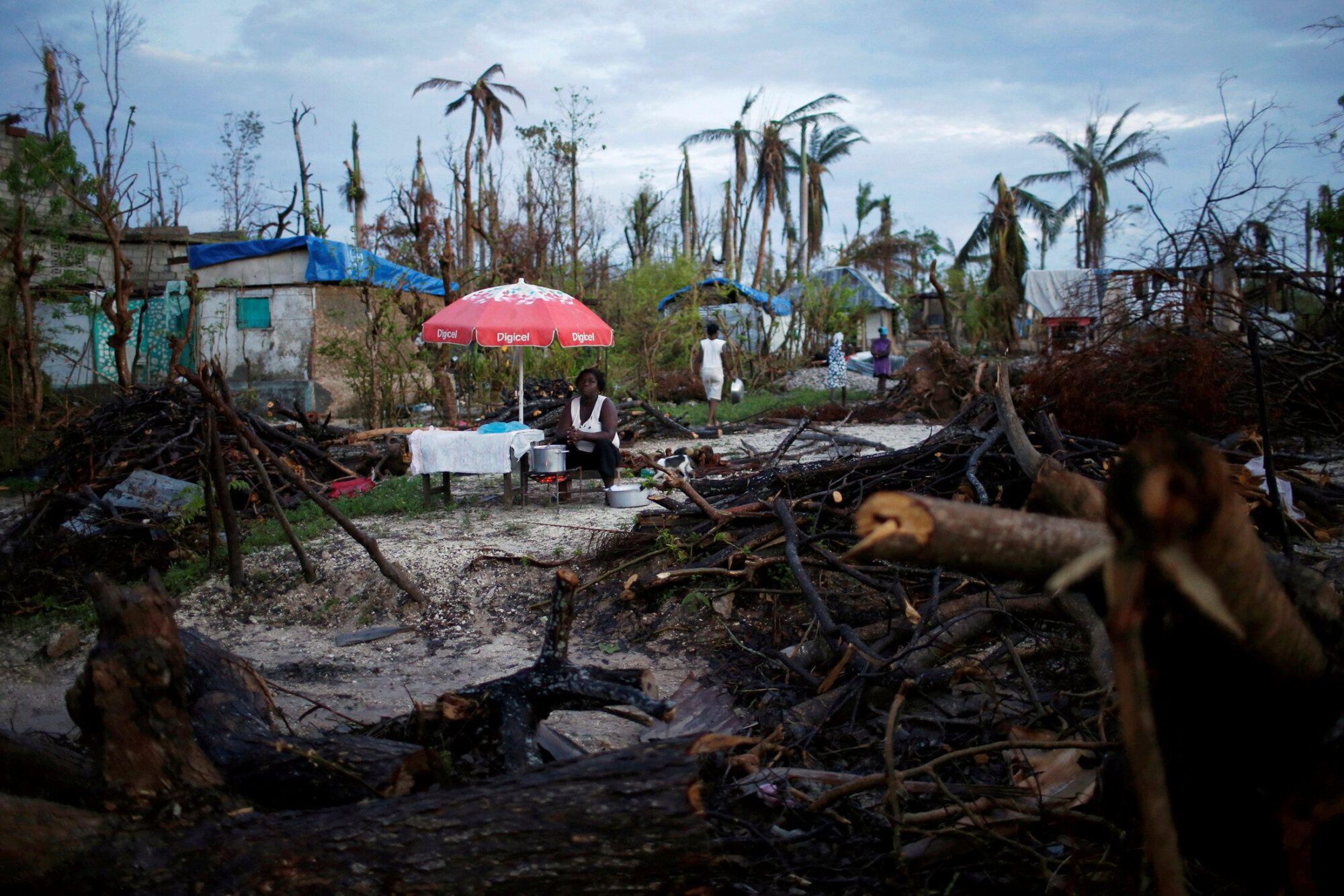<p>A food vendor works amid the damage left behind after Hurricane Matthew in Haiti, October 2016. Finance for loss and damage from climate change has been the most contentious issue at the COP27 summit (Image: Carlos Garcia Rawlins / Alamy)</p>