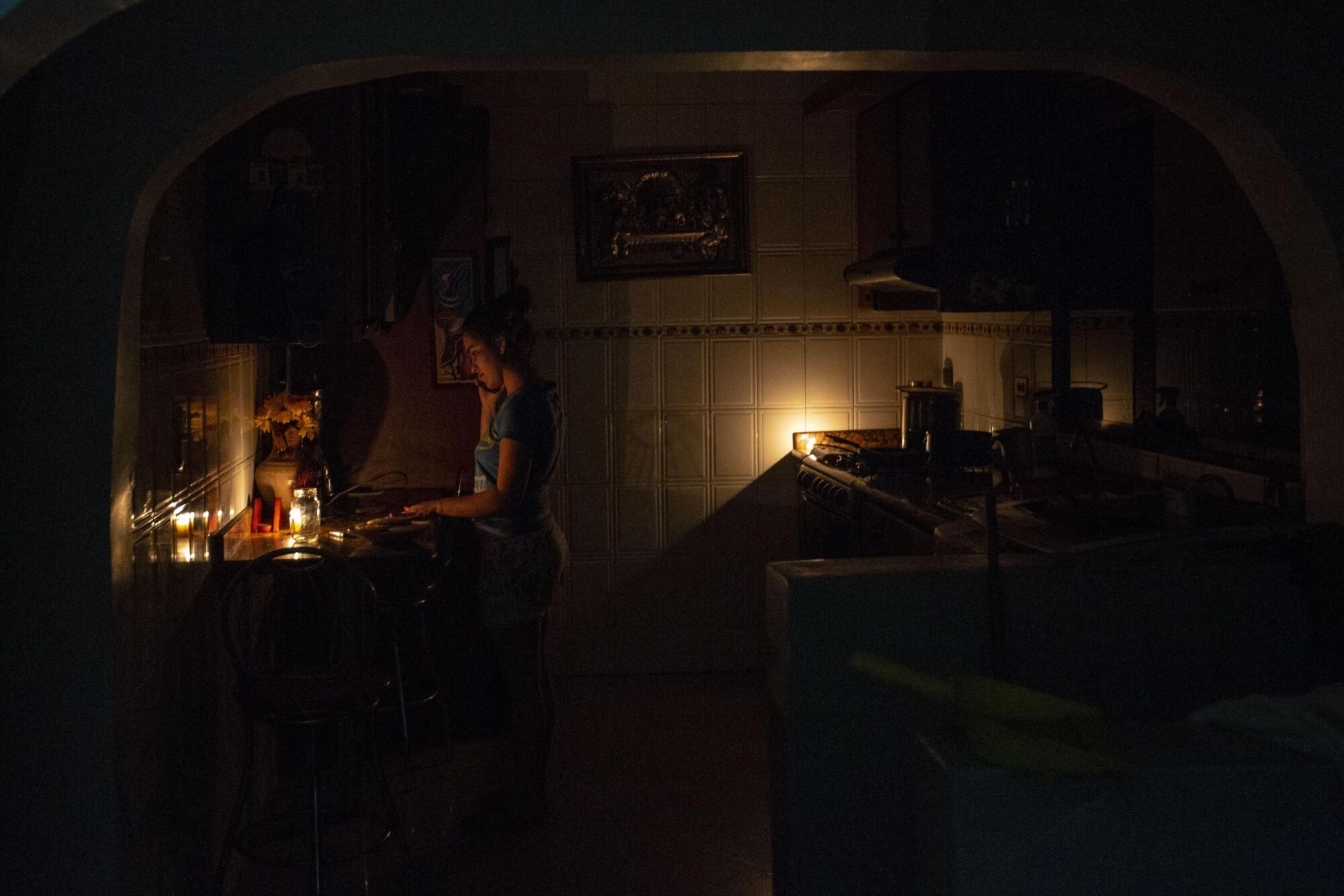 A woman inside her house in Caracas, Venezuela, on June 6, 2020 during the energy blackout
