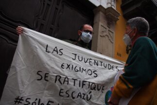 Activists holding a banner of The Youths demand that Escazu be ratified outside Peruvian Foreign Affairs Ministry