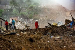 <p>Firefighters and civil defence workers search for victims following floods and landslides in Petrópolis, Brazil in February 2022 (Image: Alamy)</p>