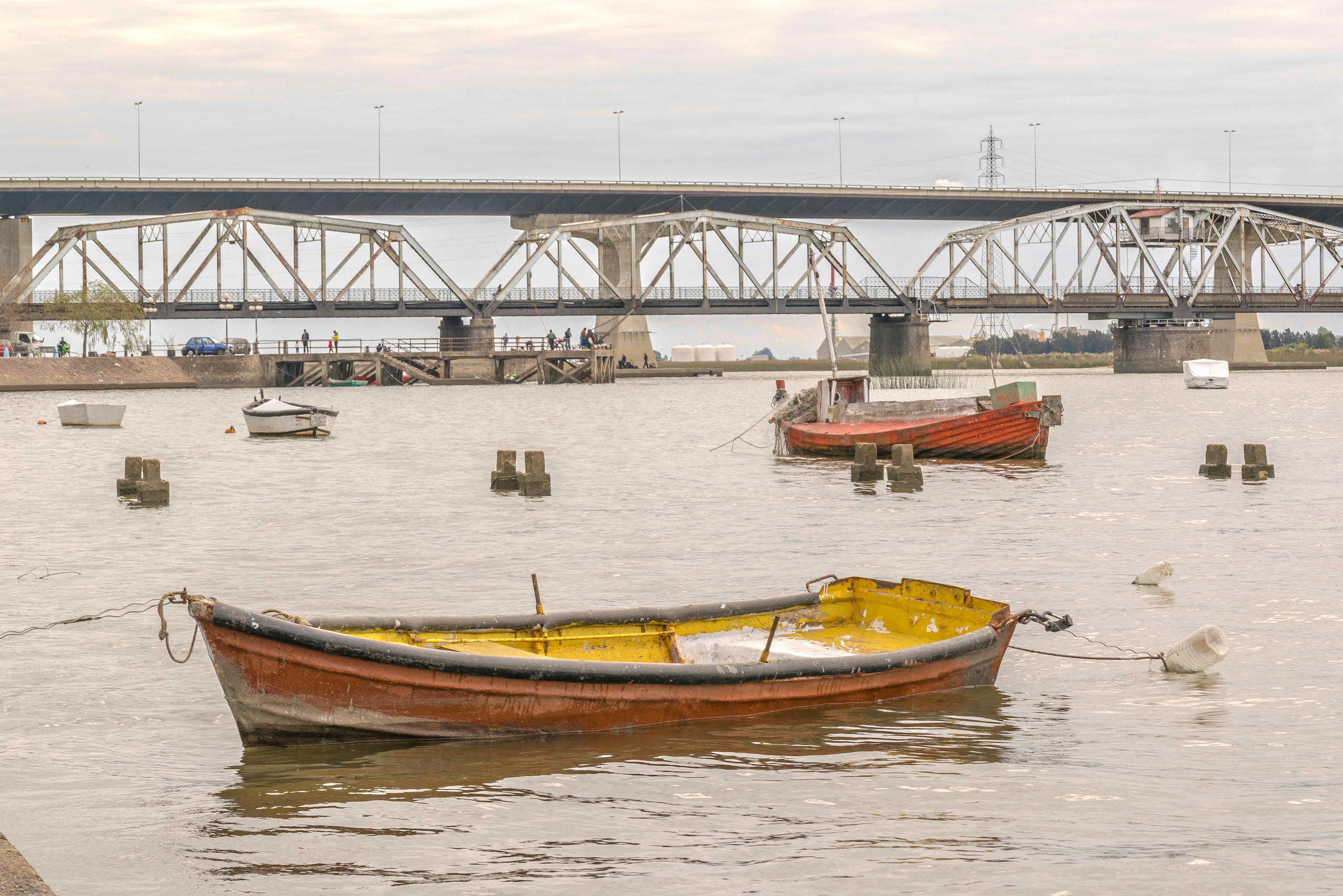 Small sailboats and fishing boats resting in the water of Santa Lucia river in the outside of Montevideo in Uruguay