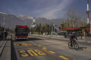 <p>An electric bus and a cyclist share a street in Santiago, Chile. The country is seen by many as a regional leader in Latin America’s energy transition. (Image: <a href="https://flic.kr/p/2mb58UD">Tamara Merino</a> / <a href="https://flickr.com/people/imfphoto/">IMF</a>, <a href="https://creativecommons.org/licenses/by-nc-nd/2.0/">CC BY-NC-ND</a>)</p>