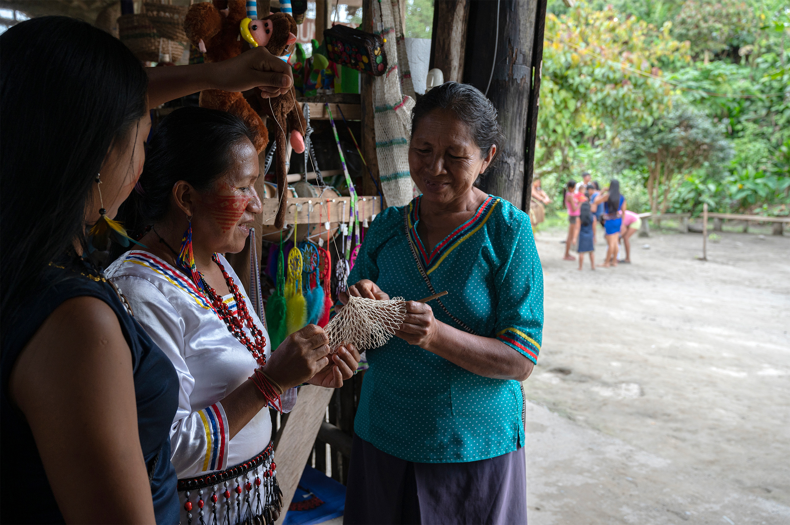 women examining handicrafts