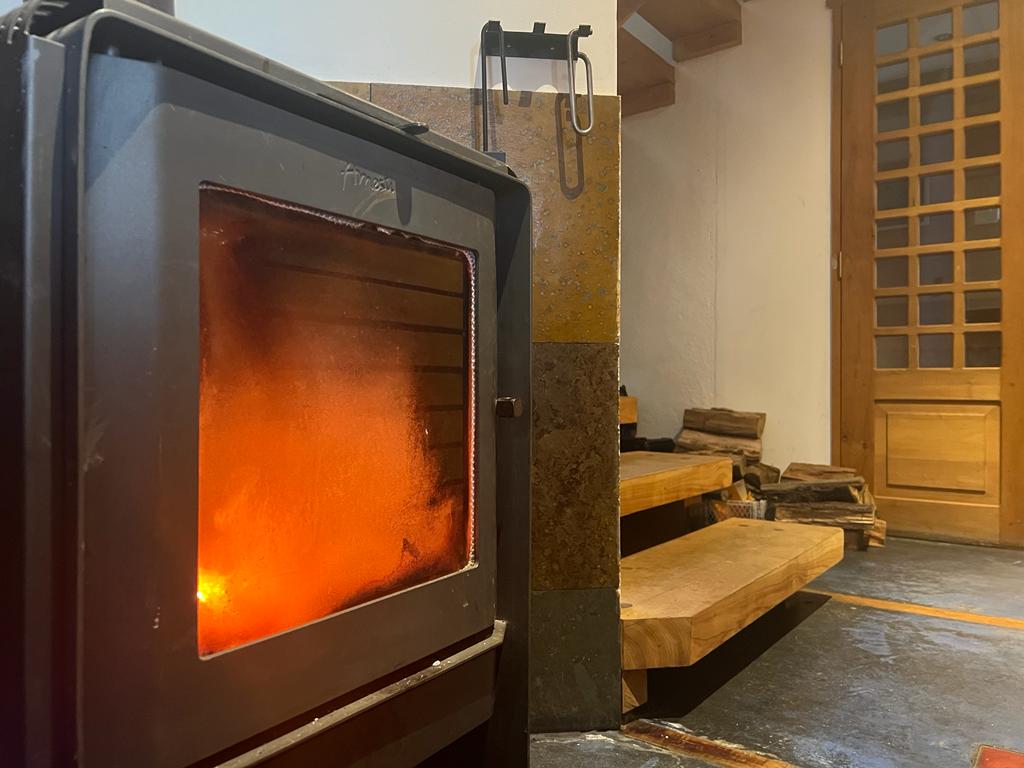 Fire burning is a wood burning stove in a home setting