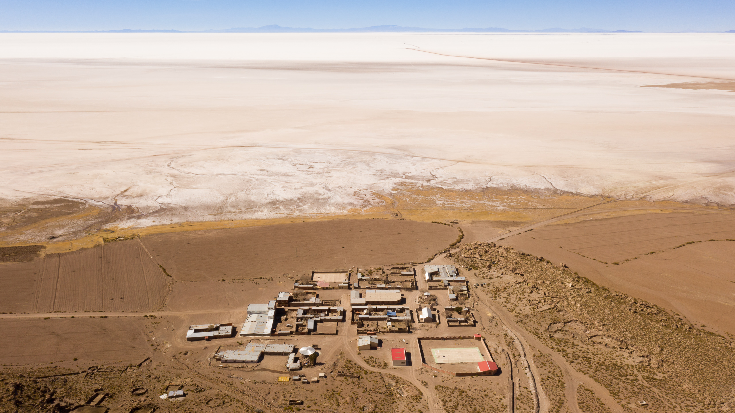 aerial view of buildings at the edge of salt flat