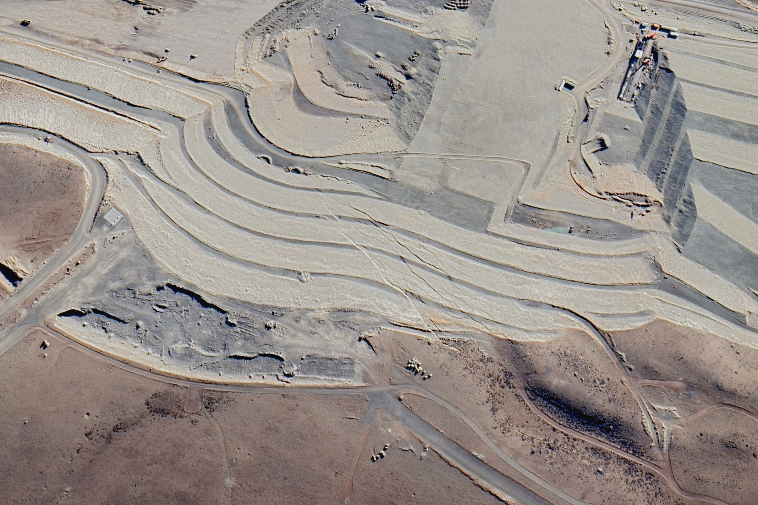 satellite photograph of a white and gray landscape crossed with lines