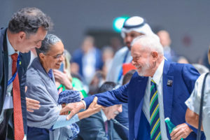 <p>Brazilian president Lula da Silva (right) greets his environment minister Marina Silva (centre) and Rodrigo Pacheco (left), president of Brazil’s congress, at COP28 in Dubai. Having made gains on halting deforestation since returning to power, Lula drew criticism at the summit for announcements on oil. (Image: <a href="https://flic.kr/p/2pj1PSj">Ricardo Stuckert</a> / <a href="https://www.flickr.com/people/palaciodoplanalto/">Palácio do Planalto</a>, <a href="https://creativecommons.org/licenses/by-nd/2.0/">CC BY-ND</a>)</p>