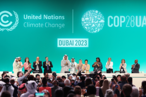 People celebrating on stage at COP28