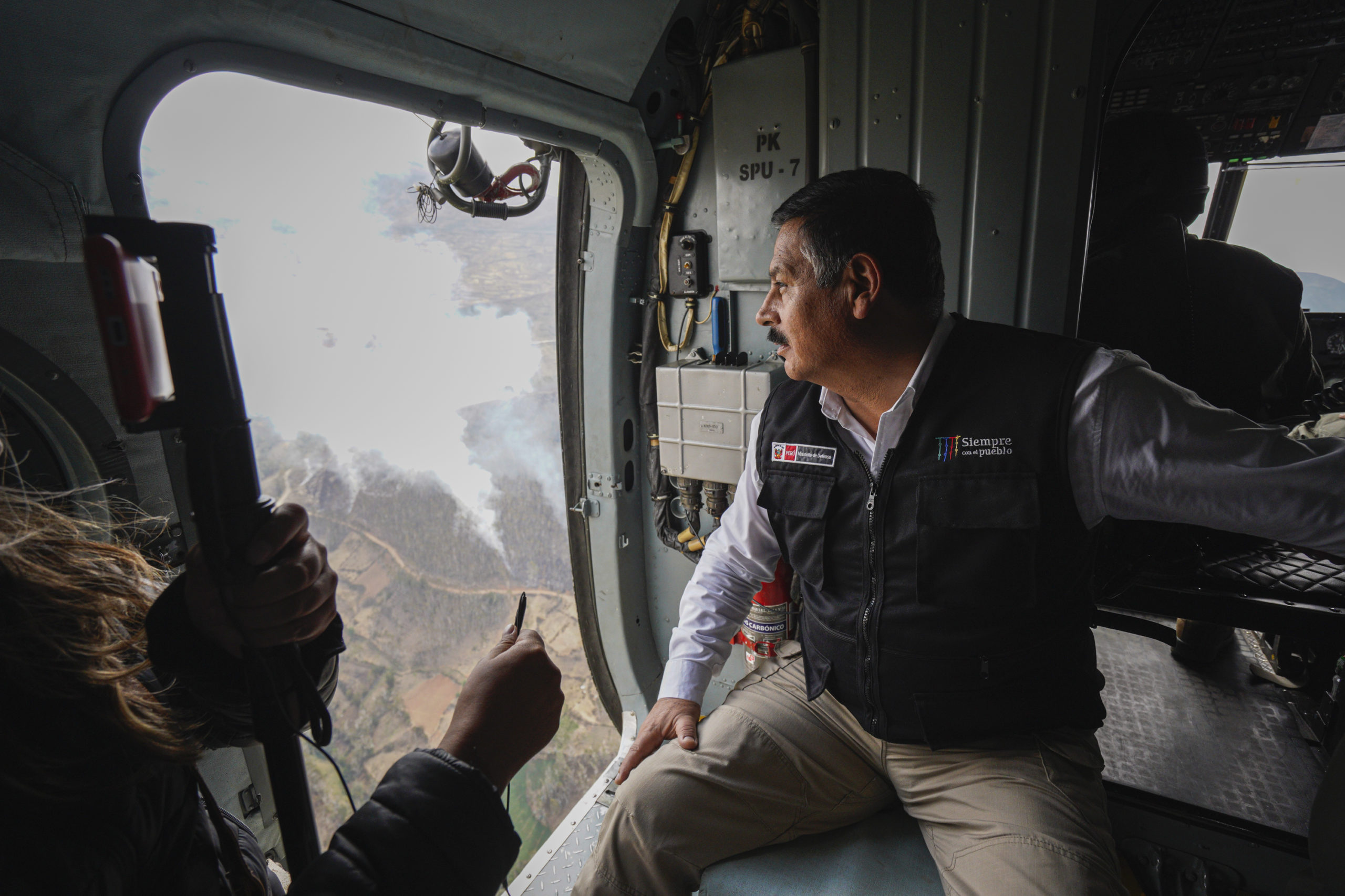 Daniel Barragán observing forest fires below from aircraft 